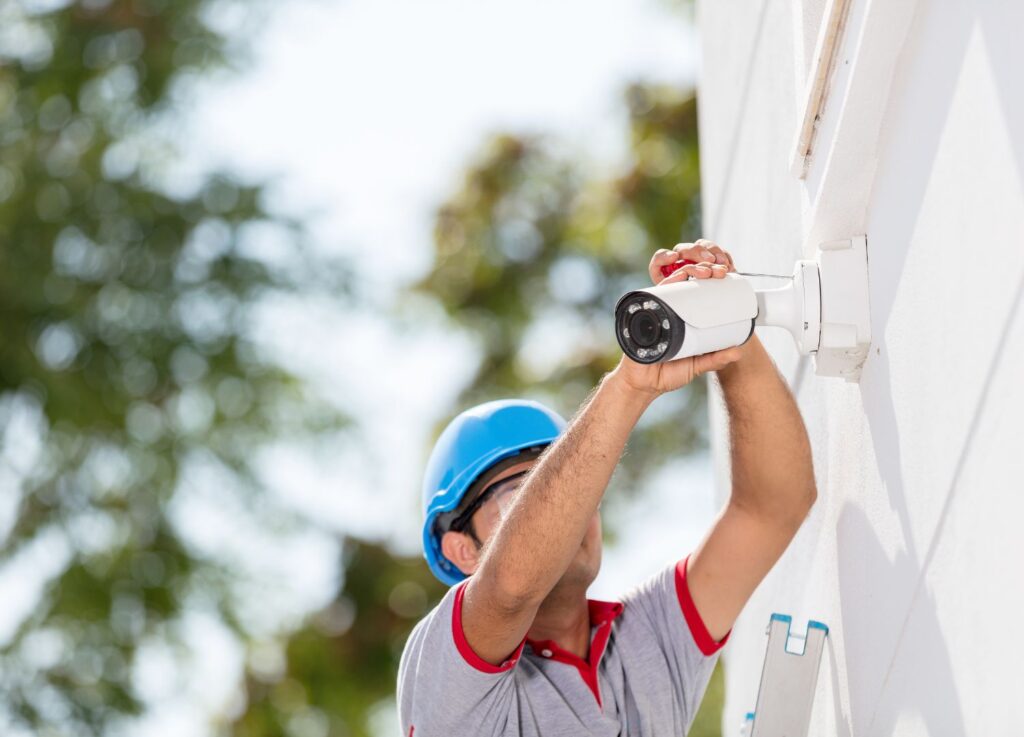 a professional installing a home security system